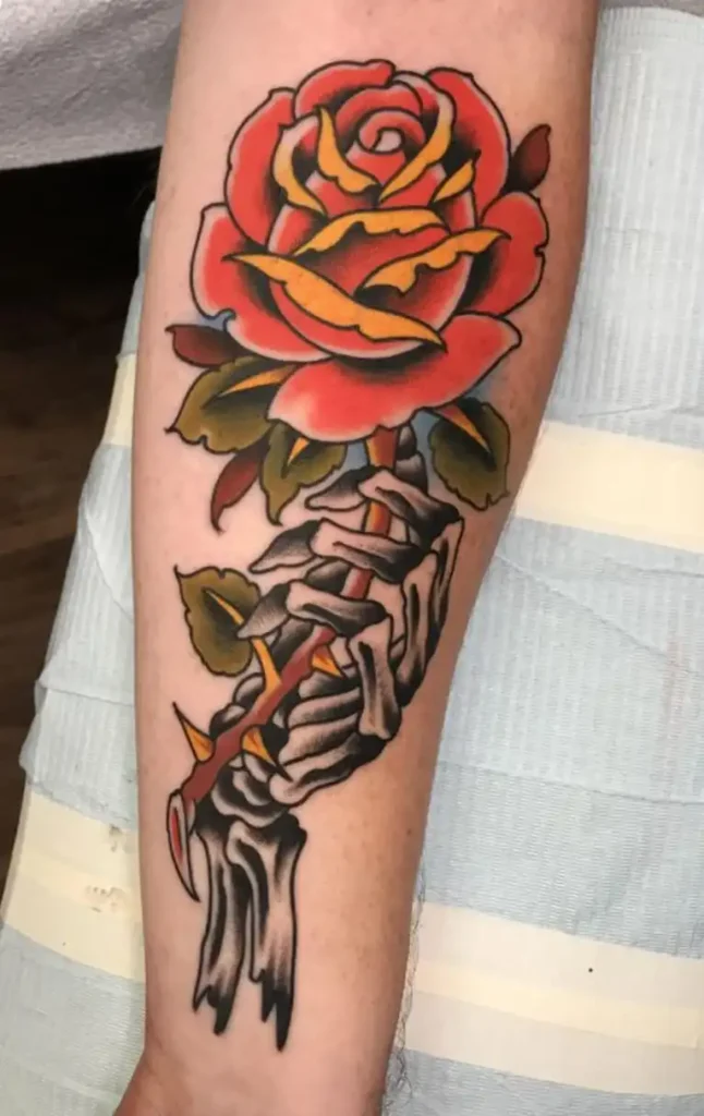 Skeleton Hand Tattoo Meaning: Symbolism History and Design Inspiration 4 Skeleton Hand Holding Flowers or Objects